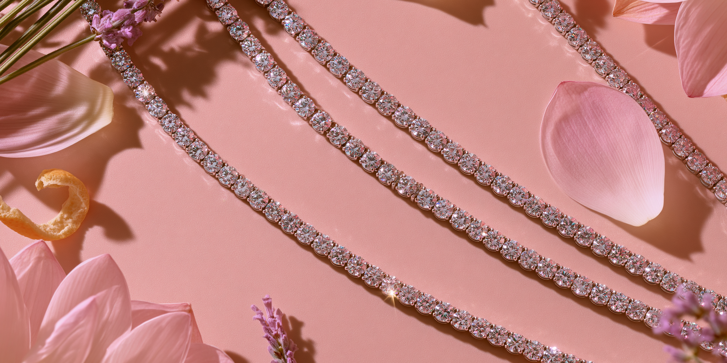 Diamond bracelets on a pink floral background