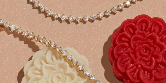 Diamond tennis bracelets on a christmas themed plate next to holly and cake
