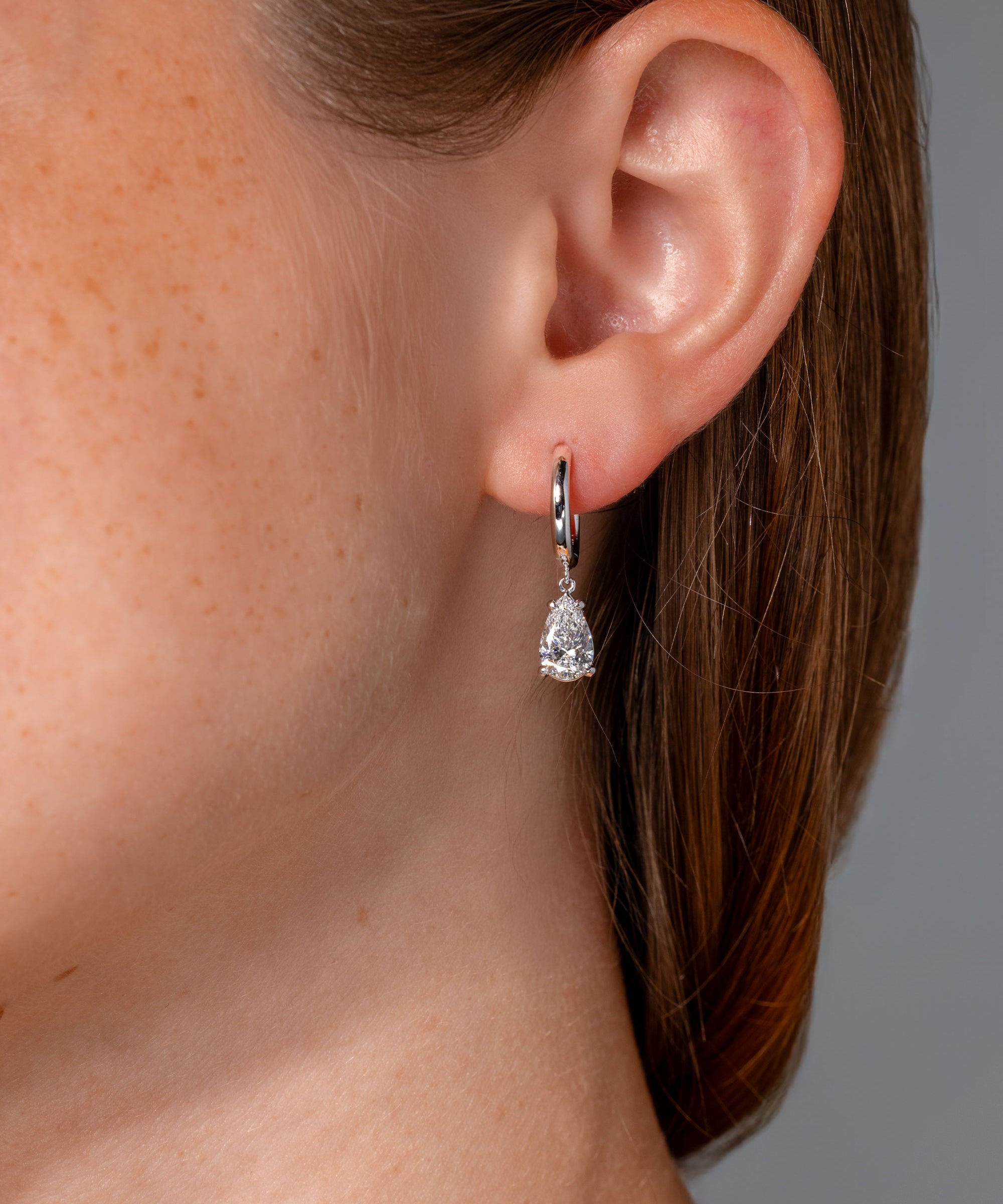 1.94ct D-VS1 Lab Diamond Pear Drop Hoops White Gold high polish with seamless snap closure at princess bride diamonds in huntington beach california on model 