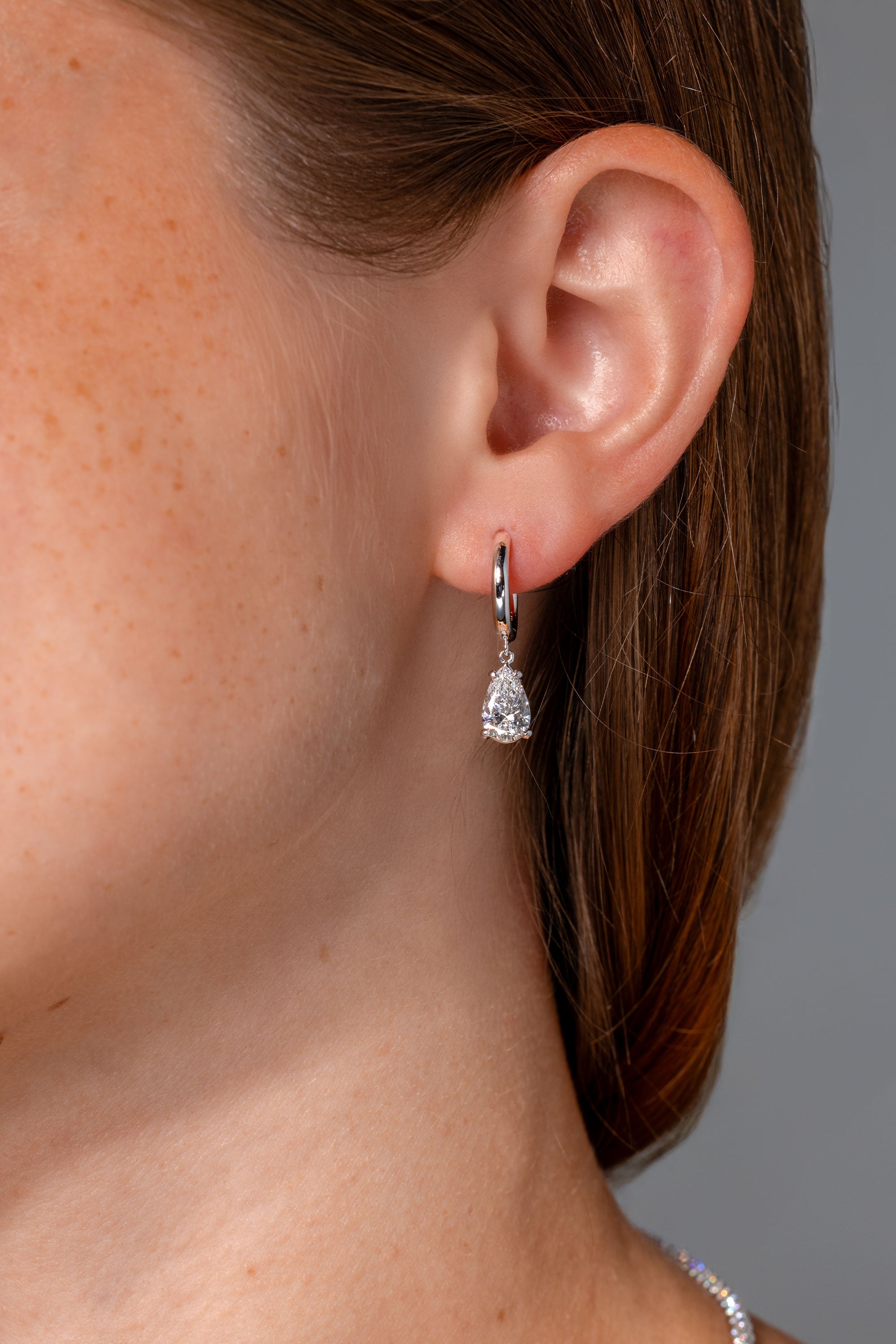1.94ct D-VS1 Lab Diamond Pear Drop Hoops White Gold high polish with seamless snap closure at princess bride diamonds in huntington beach california on model 