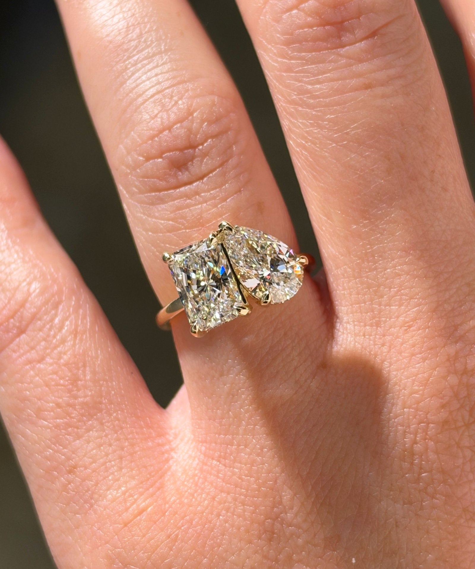2-04ct-radiant-lab-diamond-toi-et-moi-engagement-ring-14k-yellow-gold-on-hand-top-view-princess-bride-diamonds.jpg