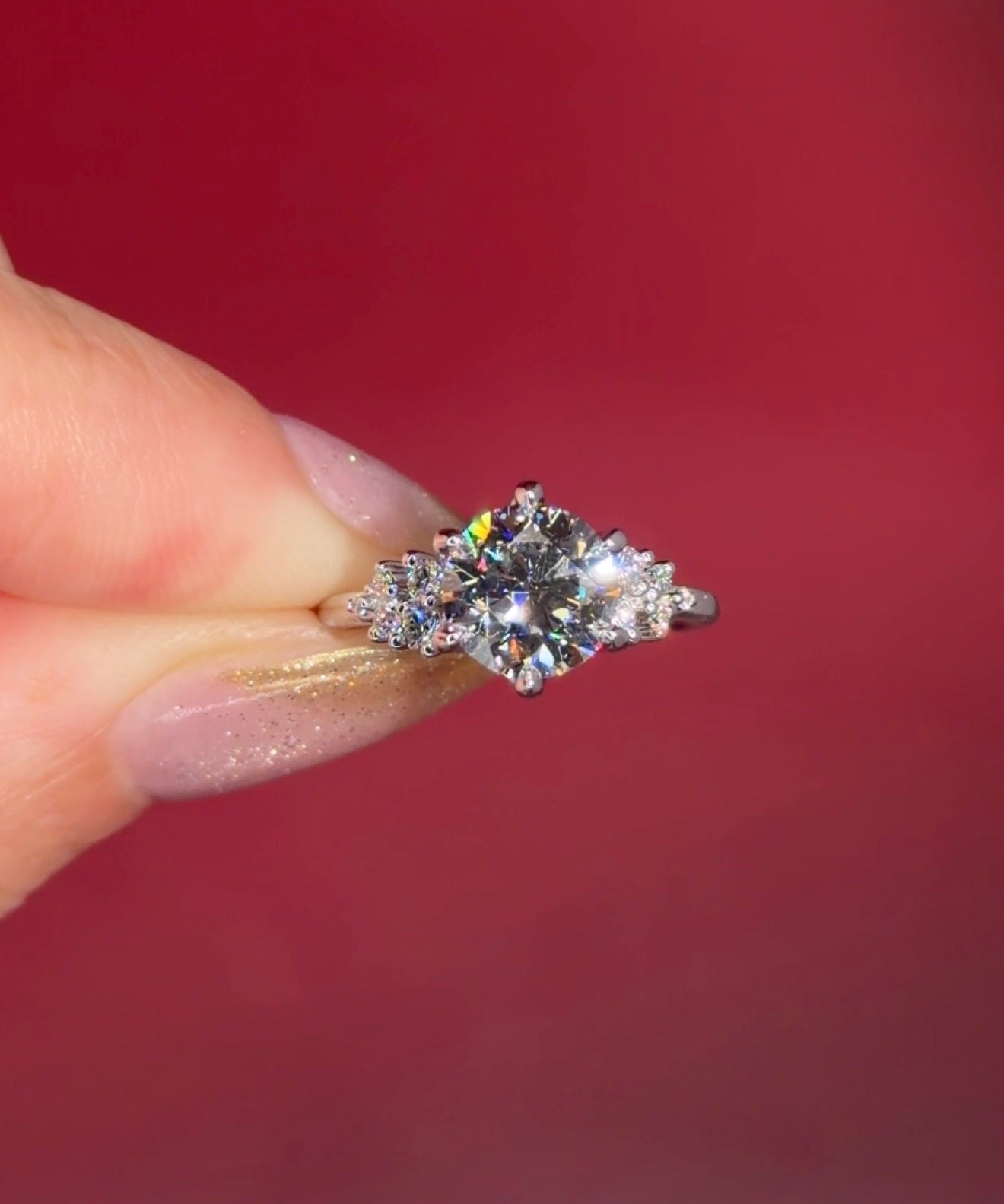 2.00ct D-VVS1 Round Lab Diamond Nova. This is a traditional body engagement ring featuring organic cluster side diamonds that resemble star dust or baby's breath. The center stone is held by our signature petal prongs.