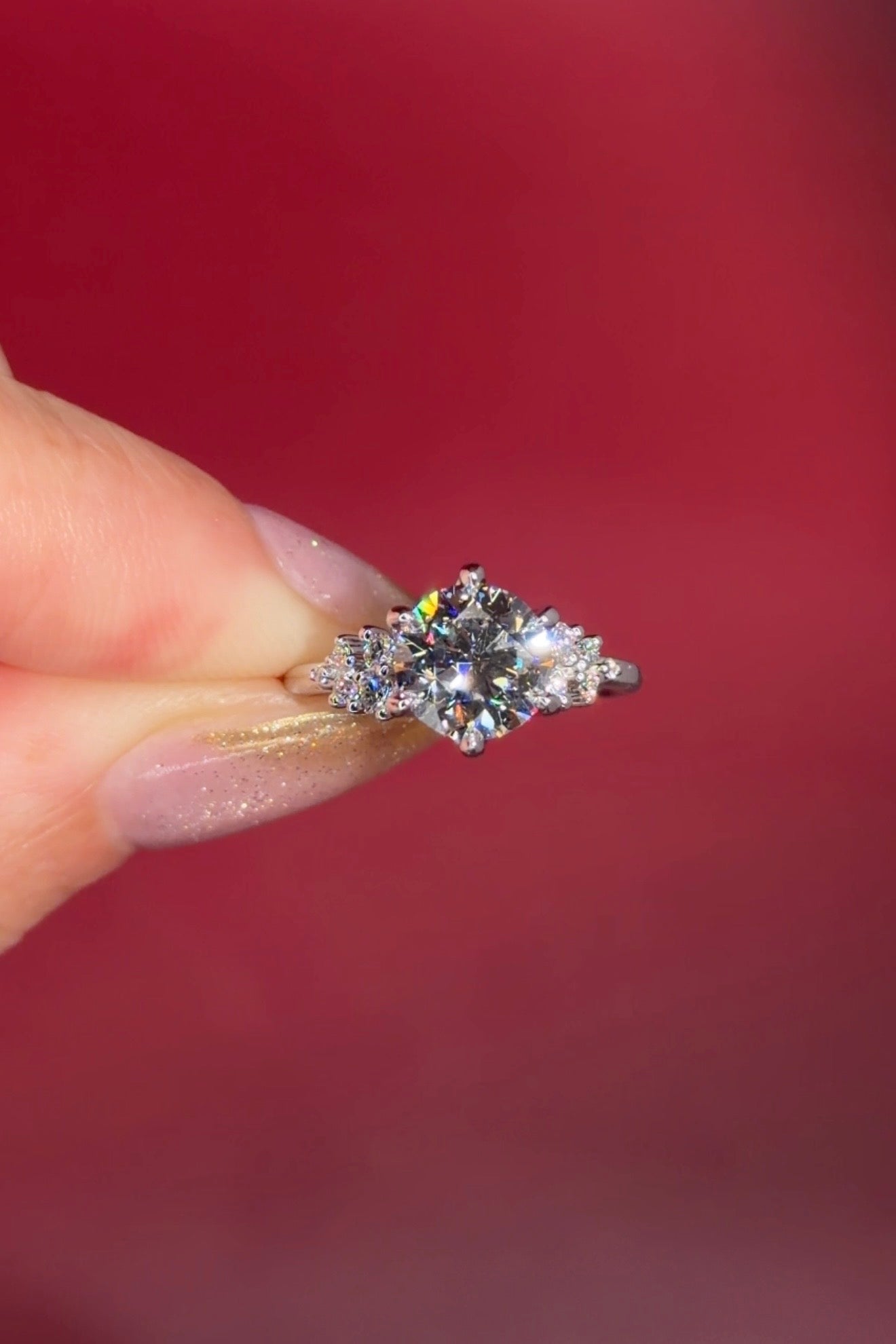 2.00ct D-VVS1 Round Lab Diamond Nova. This is a traditional body engagement ring featuring organic cluster side diamonds that resemble star dust or baby's breath. The center stone is held by our signature petal prongs.