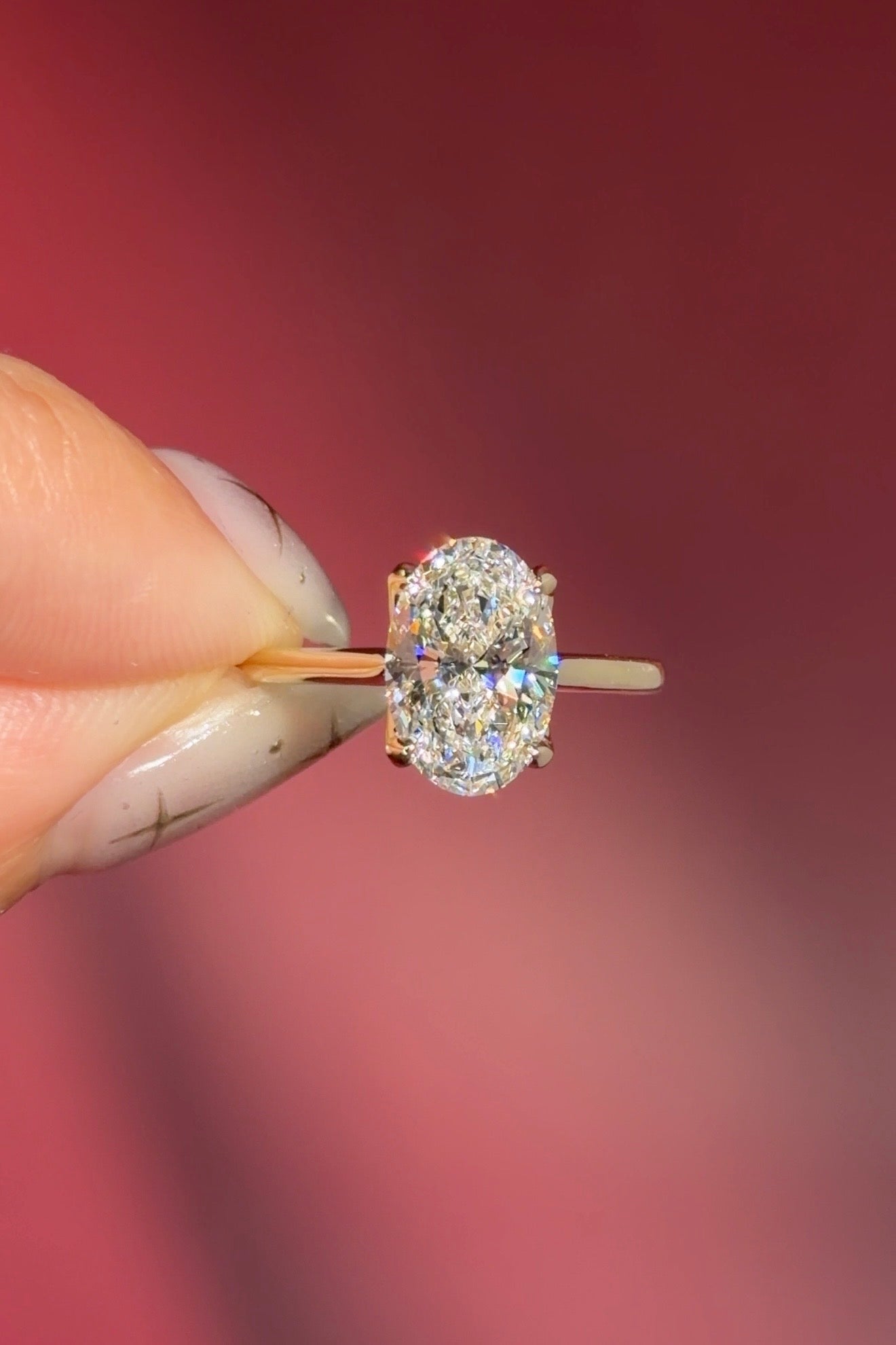 classic oval lab diamond solitaire engagement ring yellow gold cathedral setting petal prong basket