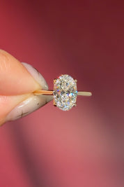 classic oval lab diamond solitaire engagement ring yellow gold cathedral setting petal prong basket