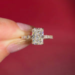 2.74ct E-VS1 Radiant Lab Diamond East West Ring. This is a traditional style engagement ring featuring a wrap under halo and east west radiant cut lab diamonds set into the band. The entire ring is made in solid 14k yellow gold.