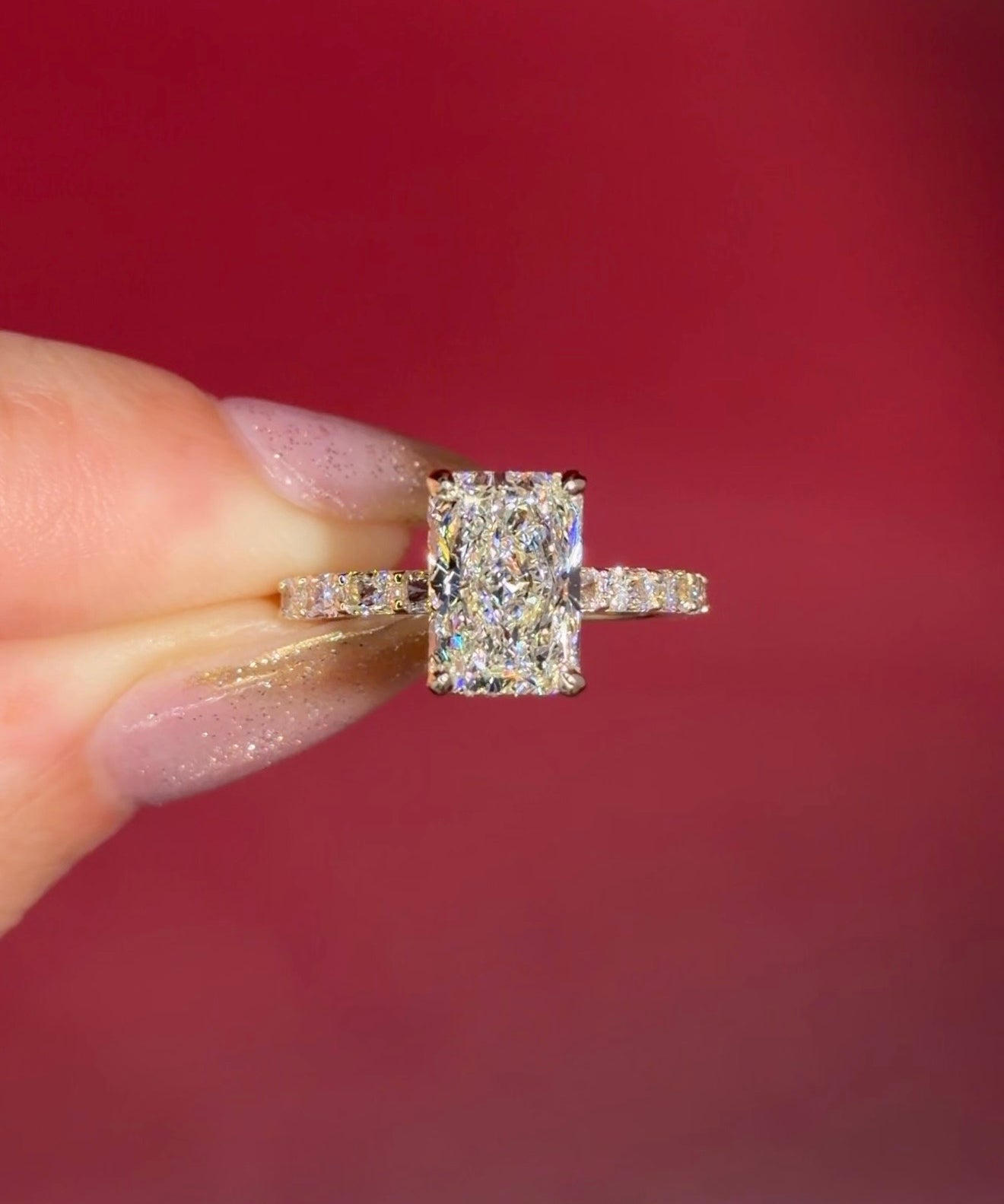 2.74ct E-VS1 Radiant Lab Diamond East West Ring. This is a traditional style engagement ring featuring a wrap under halo and east west radiant cut lab diamonds set into the band. The entire ring is made in solid 14k yellow gold.