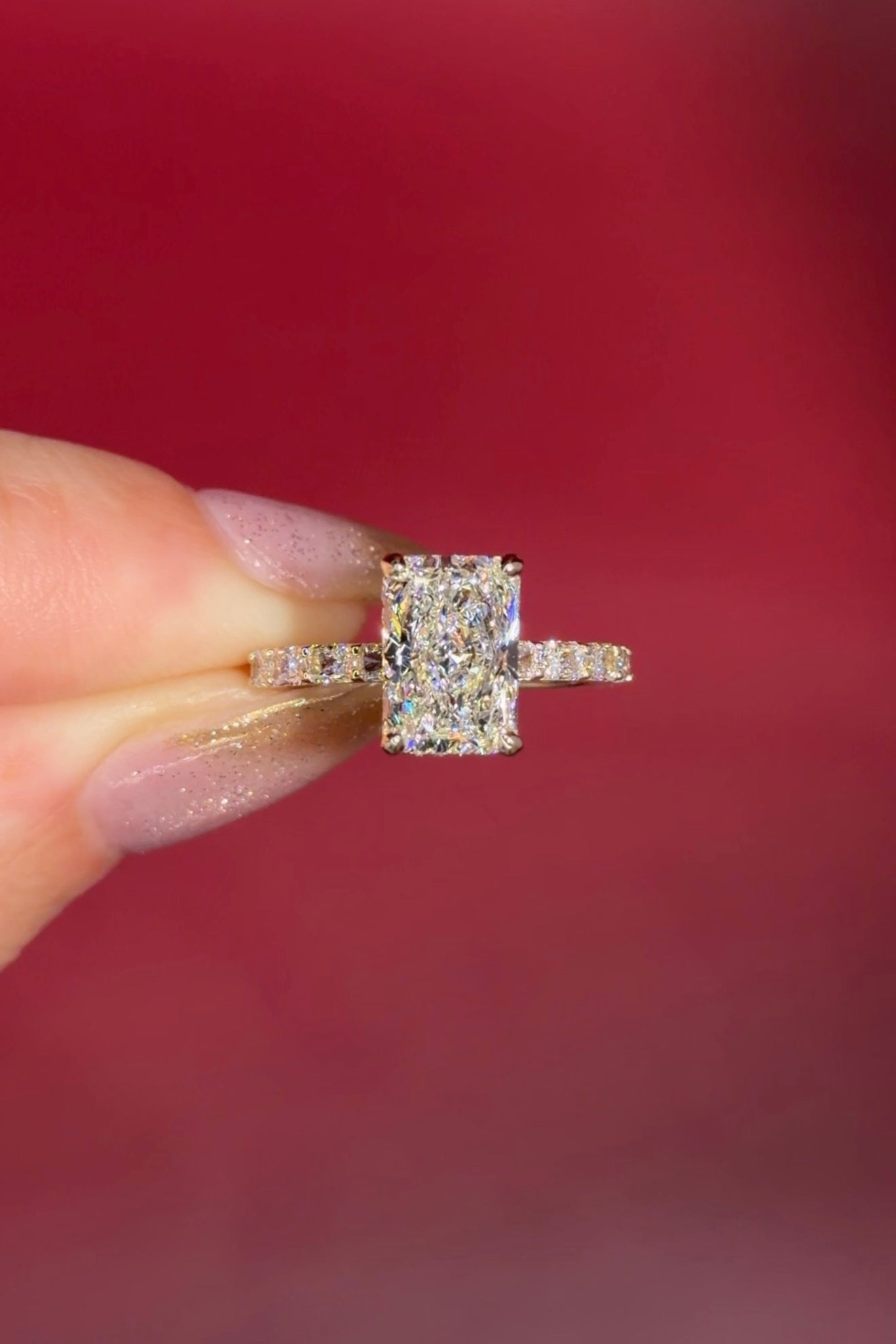 2.74ct E-VS1 Radiant Lab Diamond East West Ring. This is a traditional style engagement ring featuring a wrap under halo and east west radiant cut lab diamonds set into the band. The entire ring is made in solid 14k yellow gold.