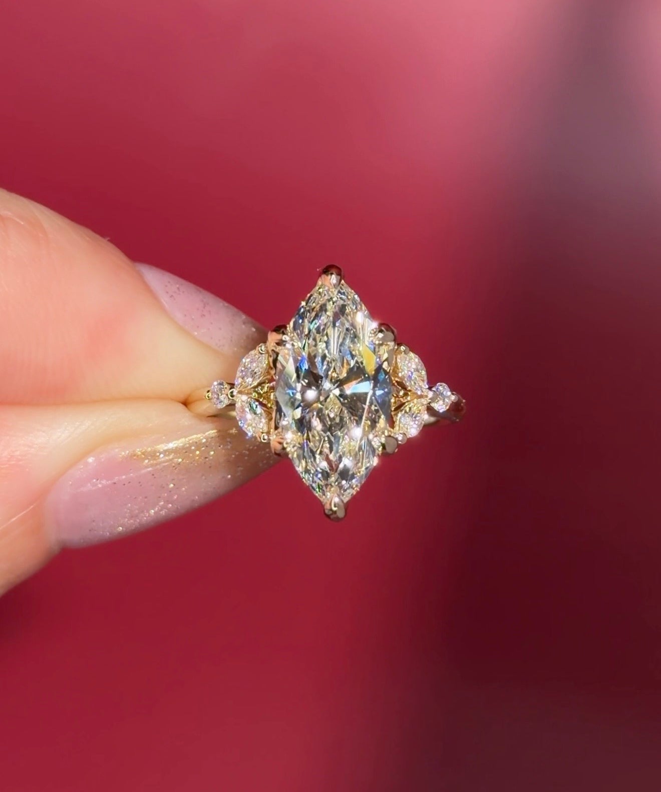 3.01ct F-VVS2 Marquise Lab Diamond Olivia. Three stone style engagement ring featuring two marquise and one round diamond at the bottom of the tro. The marquise act as diamond leaves holding the center stone. From the side profile the Olivia features a diamond bridge and diamond petal prongs.