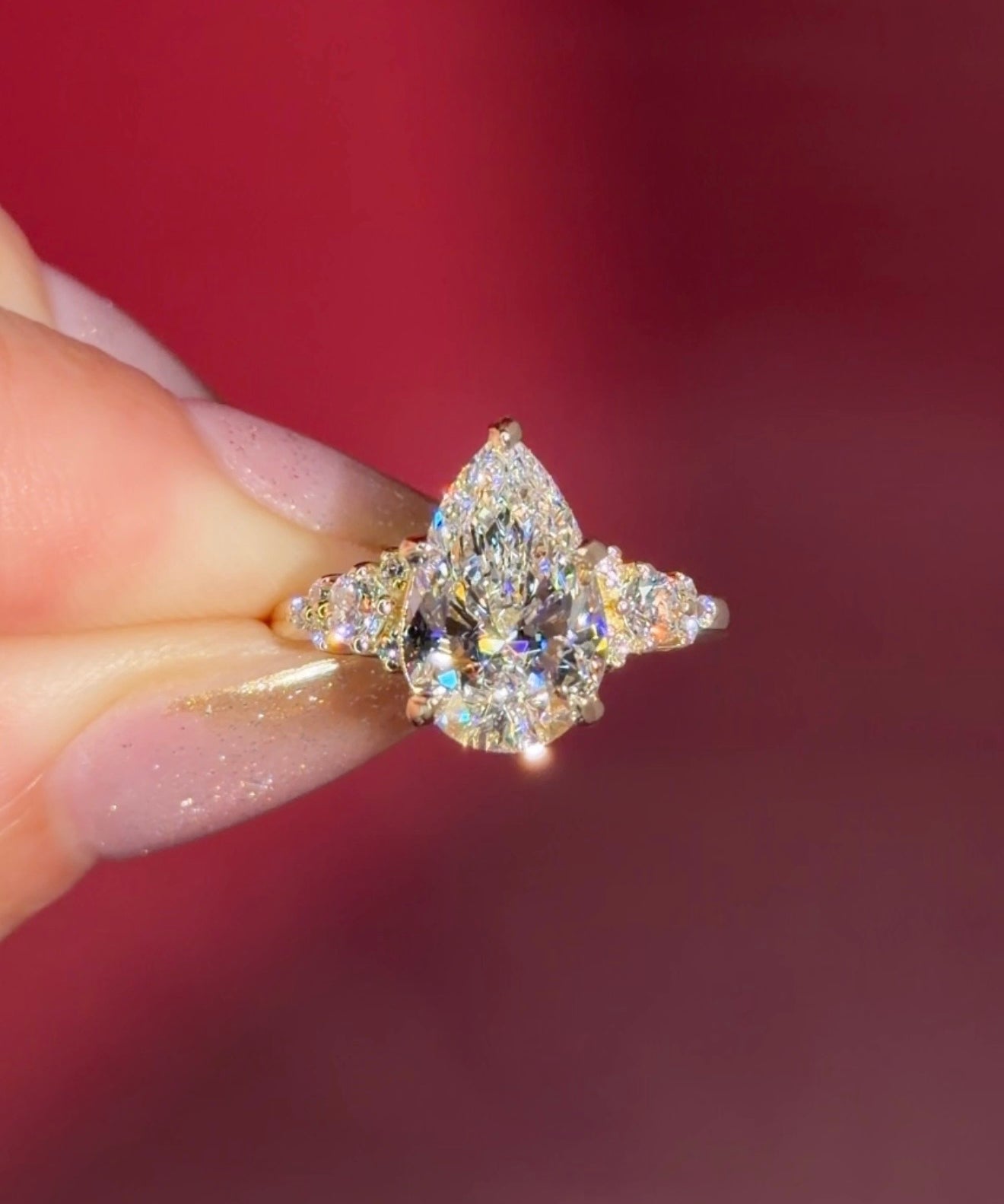 3.03ct D-VVS2 Pear Lab Diamond Brandi.

The Brandi is an inline style engagement ring featuring a symmetrical cluster of side diamonds that create a bold, sculptural look&nbsp;

Because of its inline design, straight wedding bands will not stack flush. This style pairs best with a curved or custom wedding band, or it can be worn beautifully on its own without a wedding band at all&nbsp;

A striking choice for those who love a statement engagement ring with intentional design details.