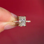 3.07ct F-VVS2 Radiant Lab Diamond Isabela. The Isabela is a cathedral style body with the key features being the pavé diamond lotus petal prongs and diamond bridge. This specific isabela is made with pavé side diamonds and is solid 14k yellow gold.
