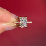 3.07ct F-VVS2 Radiant Lab Diamond Isabela. The Isabela is a cathedral style body with the key features being the pavé diamond lotus petal prongs and diamond bridge. This specific isabela is made with pavé side diamonds and is solid 14k yellow gold.
