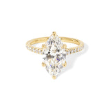 The Alice Marquise lab diamond engagement ring at Princess Bride Diamonds in Huntington Beach, California features a classic pavé diamond band with a cathedral-style setting for a higher, elegant look. It also includes a hidden under-halo beneath the center stone and a diamond bridge for added sparkle from every angle. 14k yellow gold 