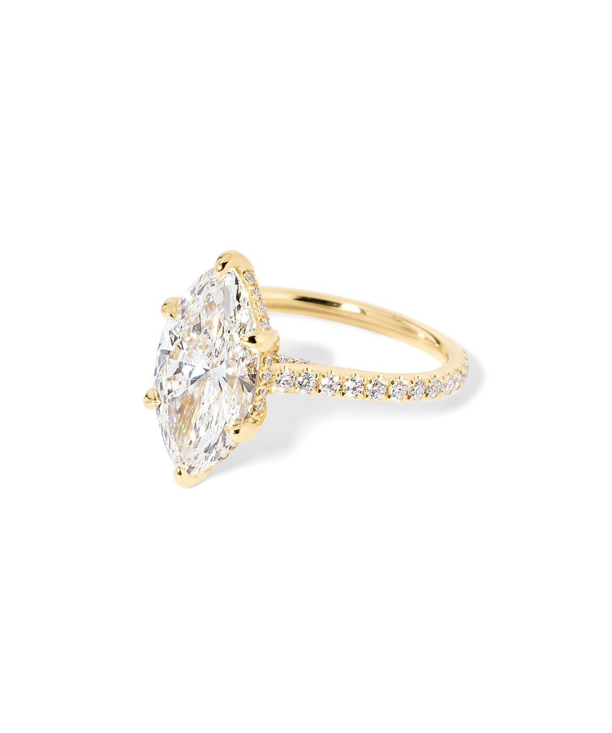 The Alice Marquise lab diamond engagement ring at Princess Bride Diamonds in Huntington Beach, California features a classic pavé diamond band with a cathedral-style setting for a higher, elegant look. It also includes a hidden under-halo beneath the center stone and a diamond bridge for added sparkle from every angle. 14k yellow gold 