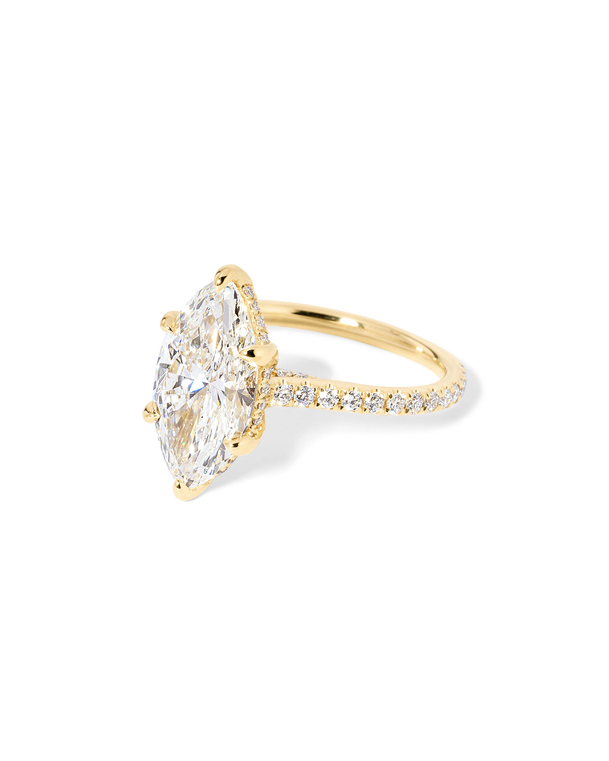 The Alice Marquise lab diamond engagement ring at Princess Bride Diamonds in Huntington Beach, California features a classic pavé diamond band with a cathedral-style setting for a higher, elegant look. It also includes a hidden under-halo beneath the center stone and a diamond bridge for added sparkle from every angle. 14k yellow gold 