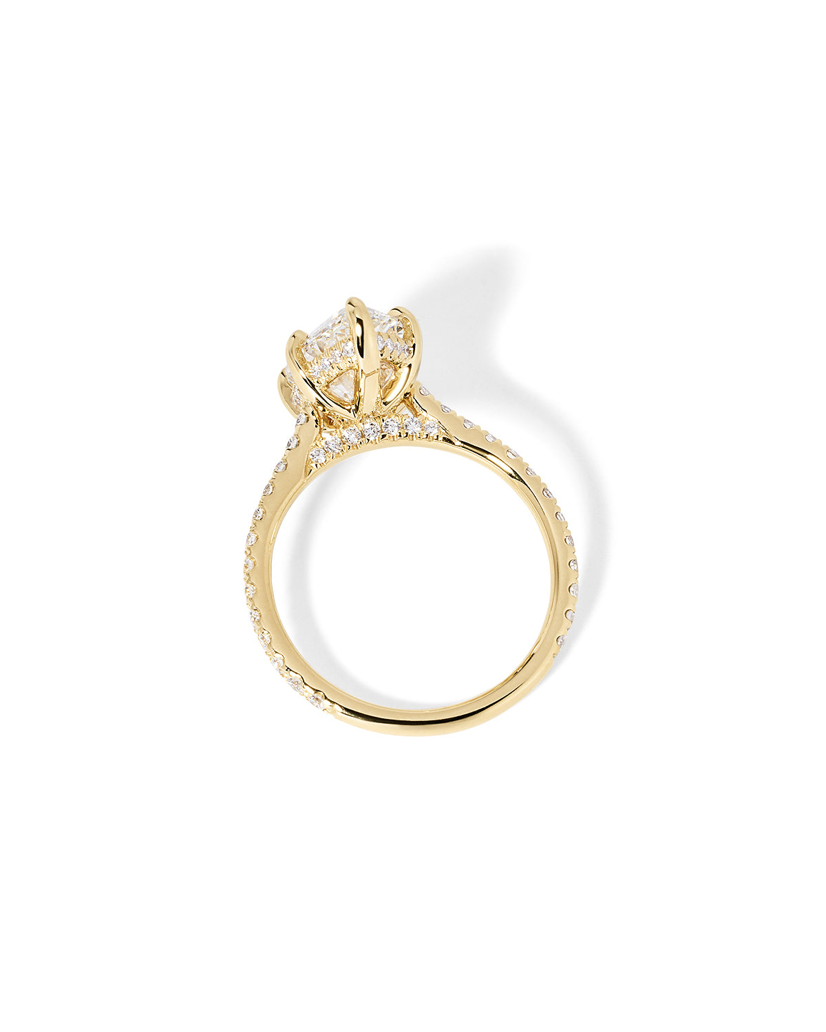 The Alice Marquise lab diamond engagement ring at Princess Bride Diamonds in Huntington Beach, California features a classic pavé diamond band with a cathedral-style setting for a higher, elegant look. It also includes a hidden under-halo beneath the center stone and a diamond bridge for added sparkle from every angle. 14k yellow gold 