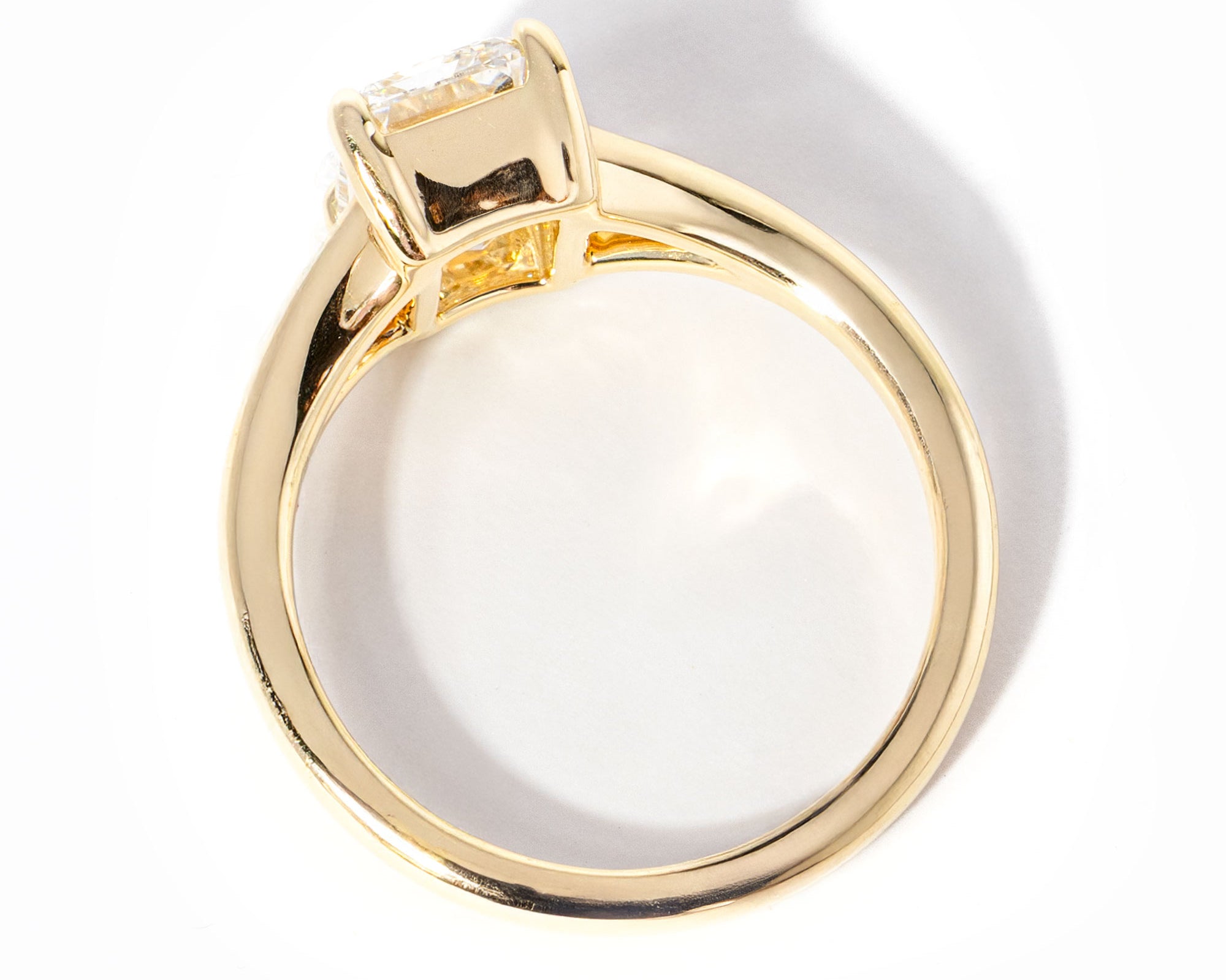 emerald cut diamond on split shank yellow gold ring
