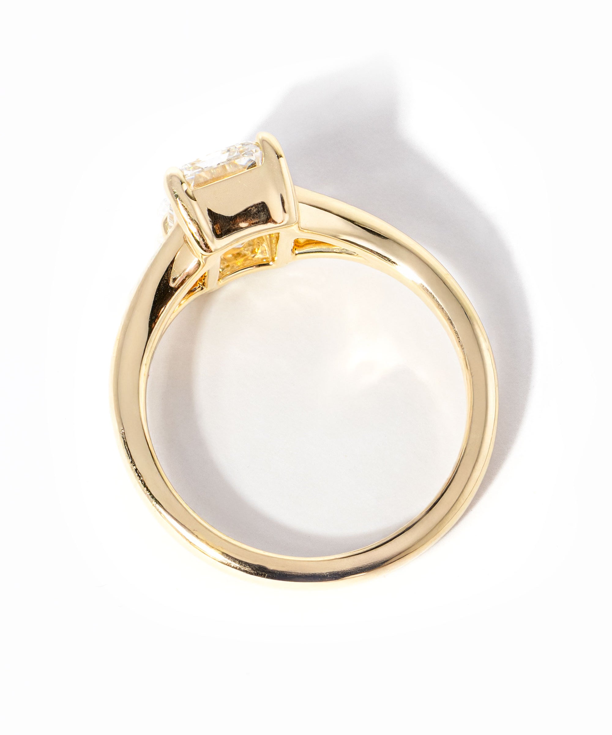 emerald cut diamond on split shank yellow gold ring