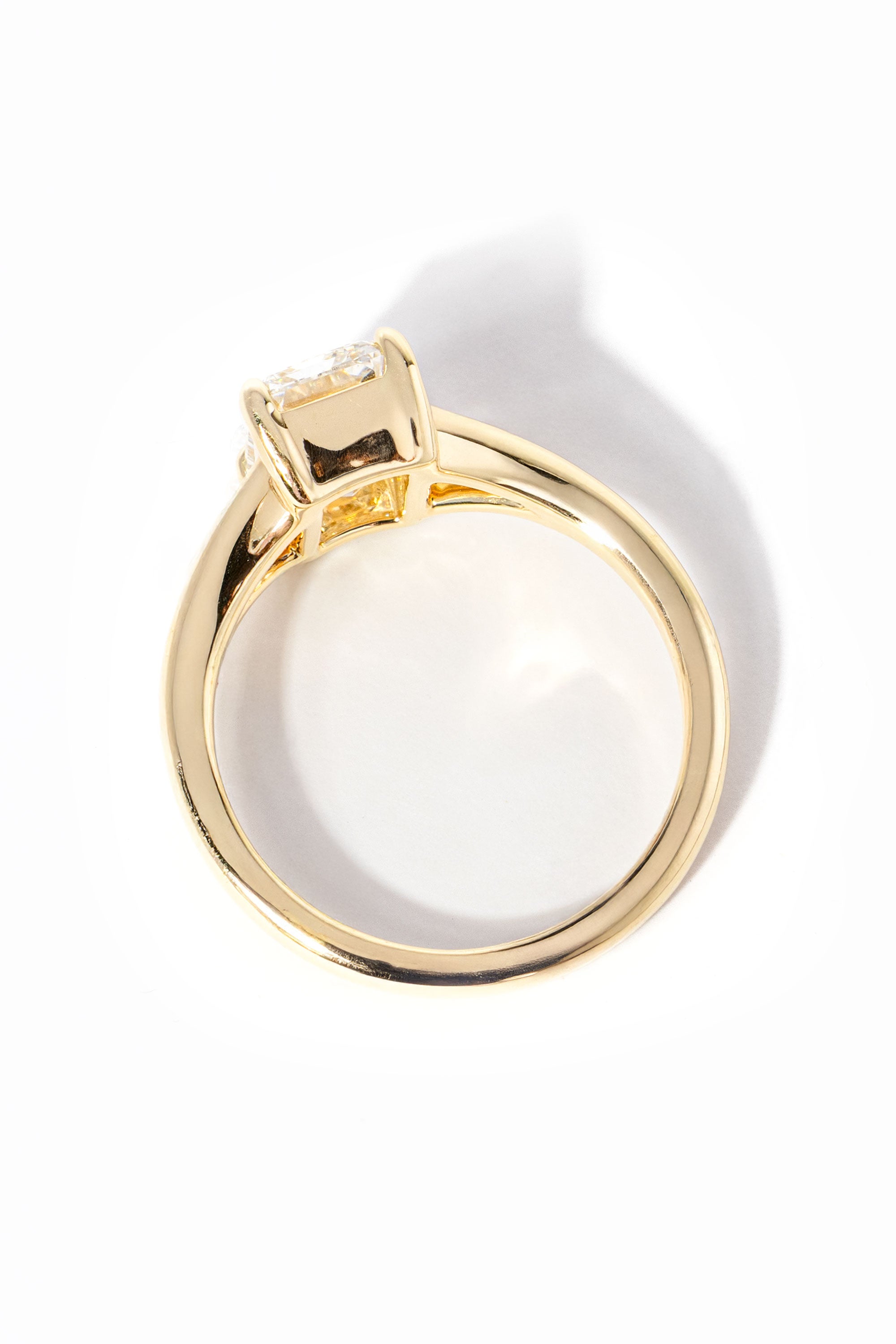 emerald cut diamond on split shank yellow gold ring