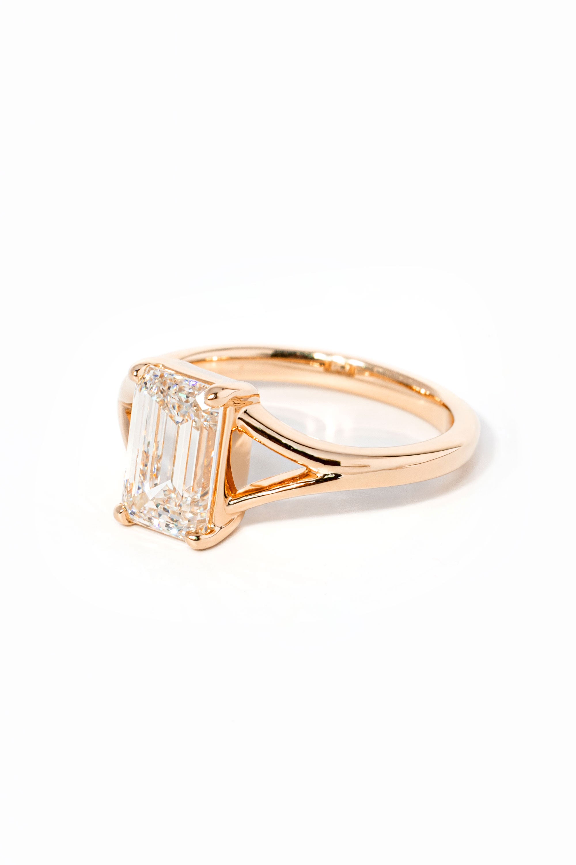 emerald cut diamond on split shank rose gold ring
