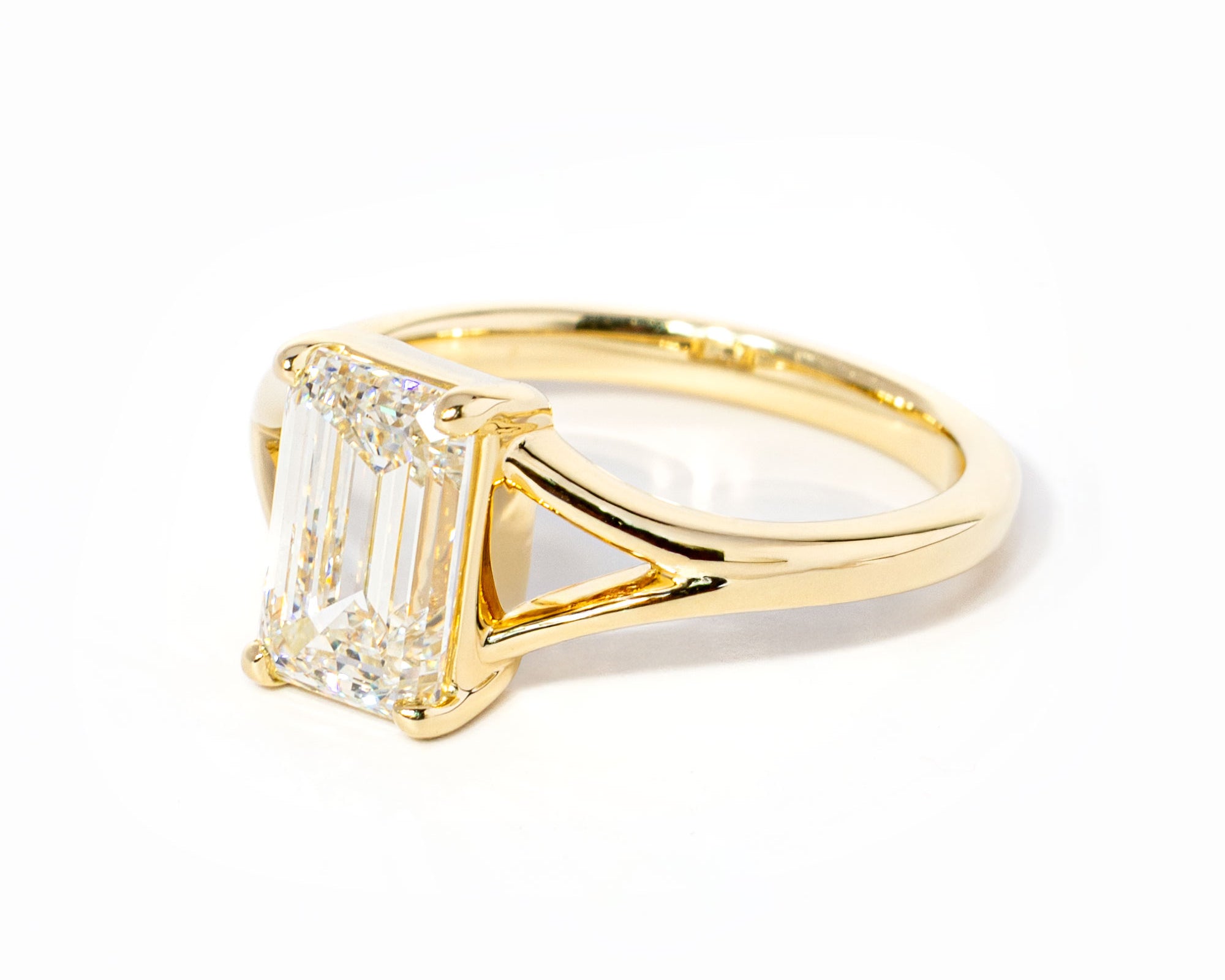 emerald cut diamond on split shank yellow gold ring