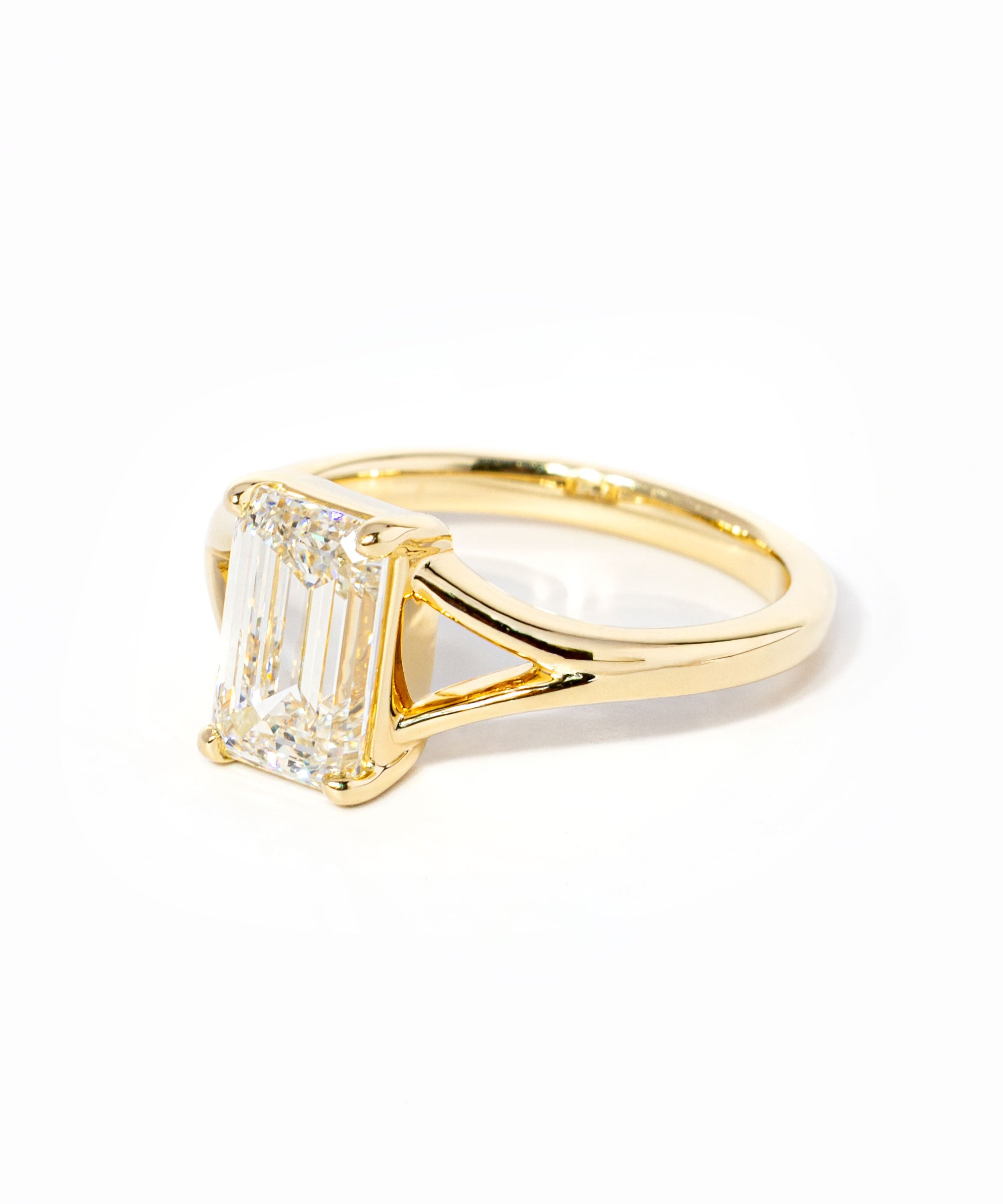 emerald cut diamond on split shank yellow gold ring