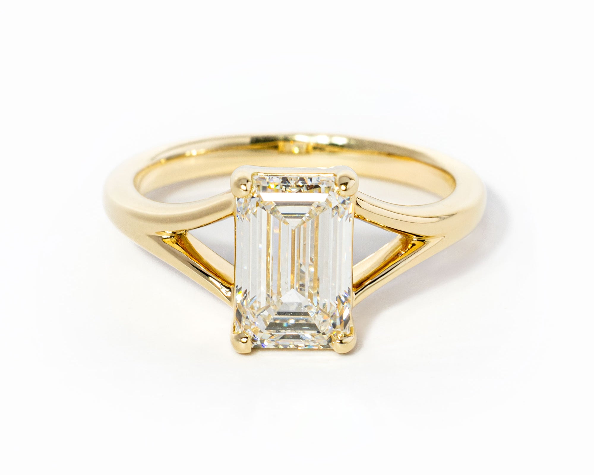emerald cut diamond on split shank yellow gold ring