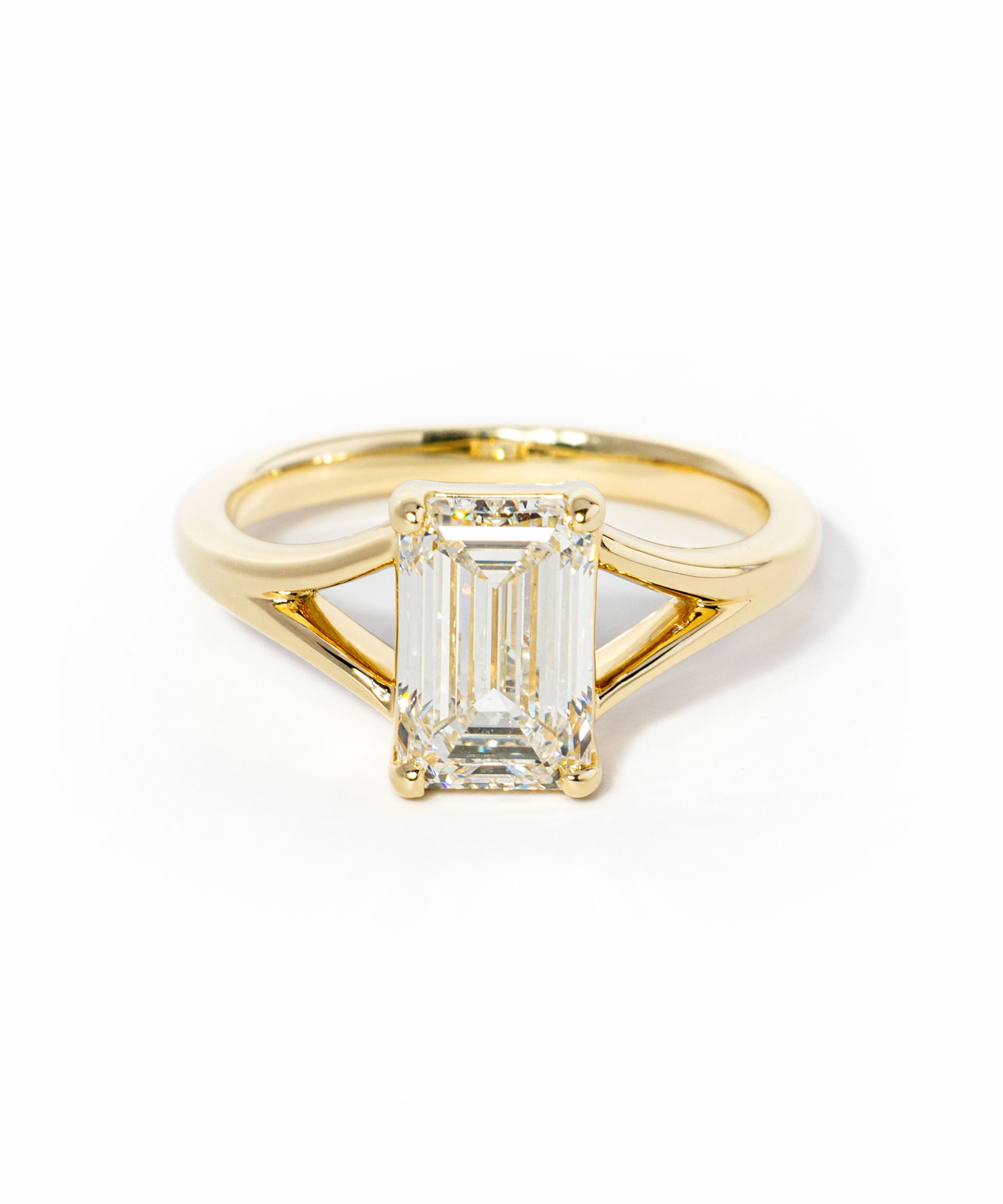 emerald cut diamond on split shank yellow gold ring