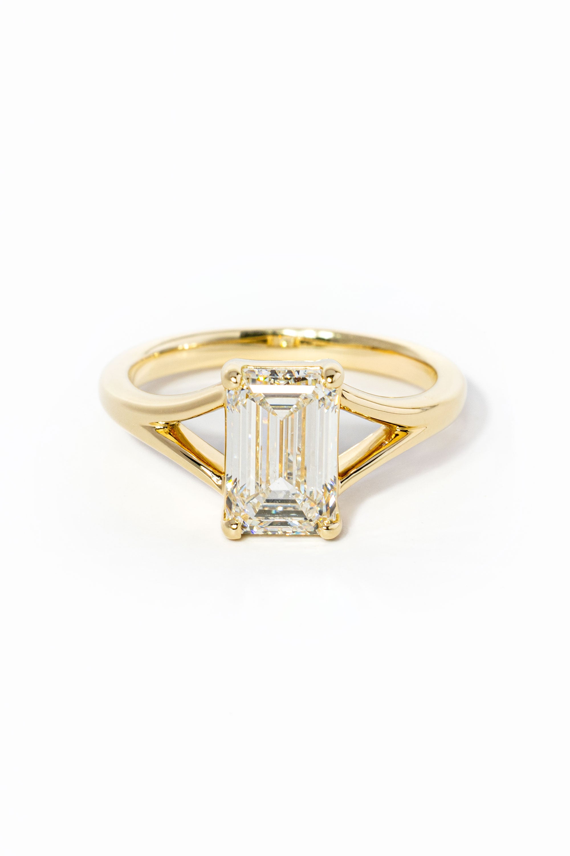 emerald cut diamond on split shank yellow gold ring