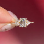 emerald lab diamond engagement ring trio side stone cluster yellow gold