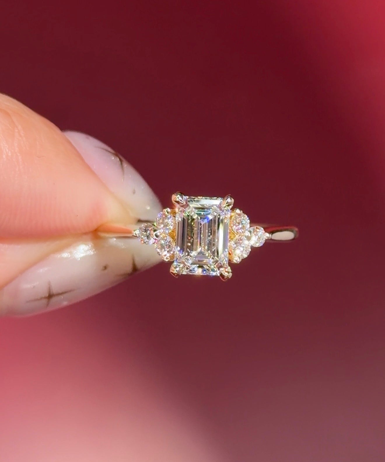 emerald lab diamond engagement ring trio side stone cluster yellow gold