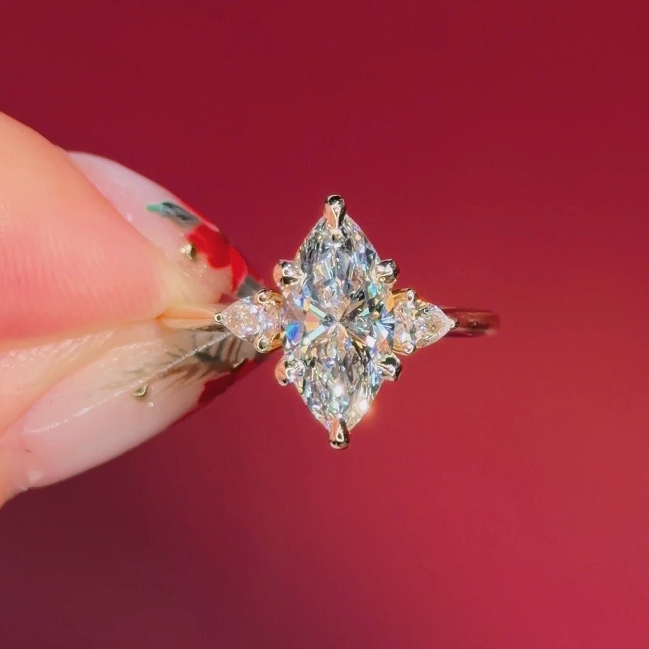 marquise yellow gold engagement ring with pear side stones