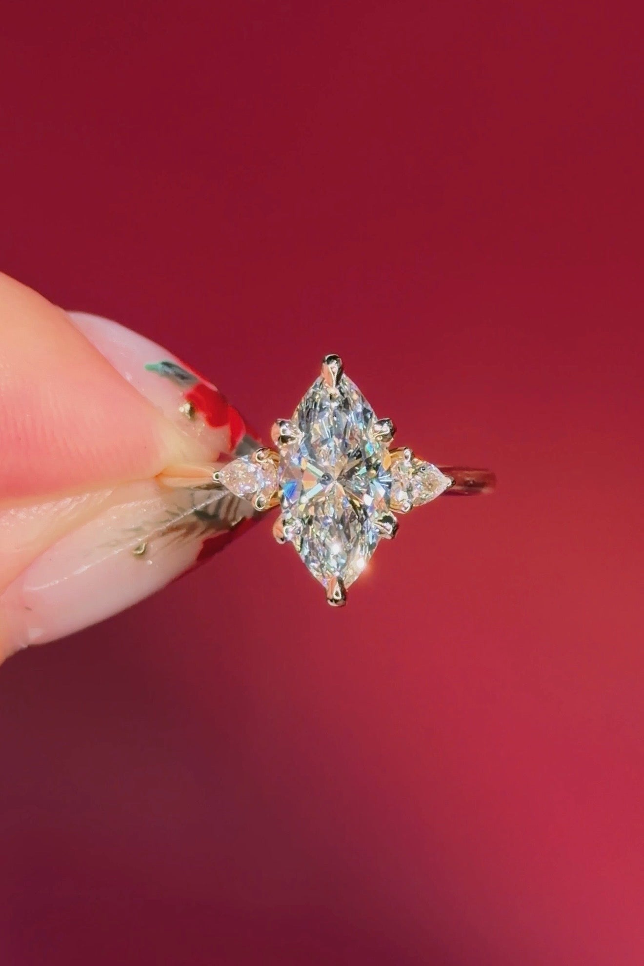 marquise yellow gold engagement ring with pear side stones