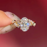 oval lab diamond cluster side stones whimsical yellow gold engagement ring