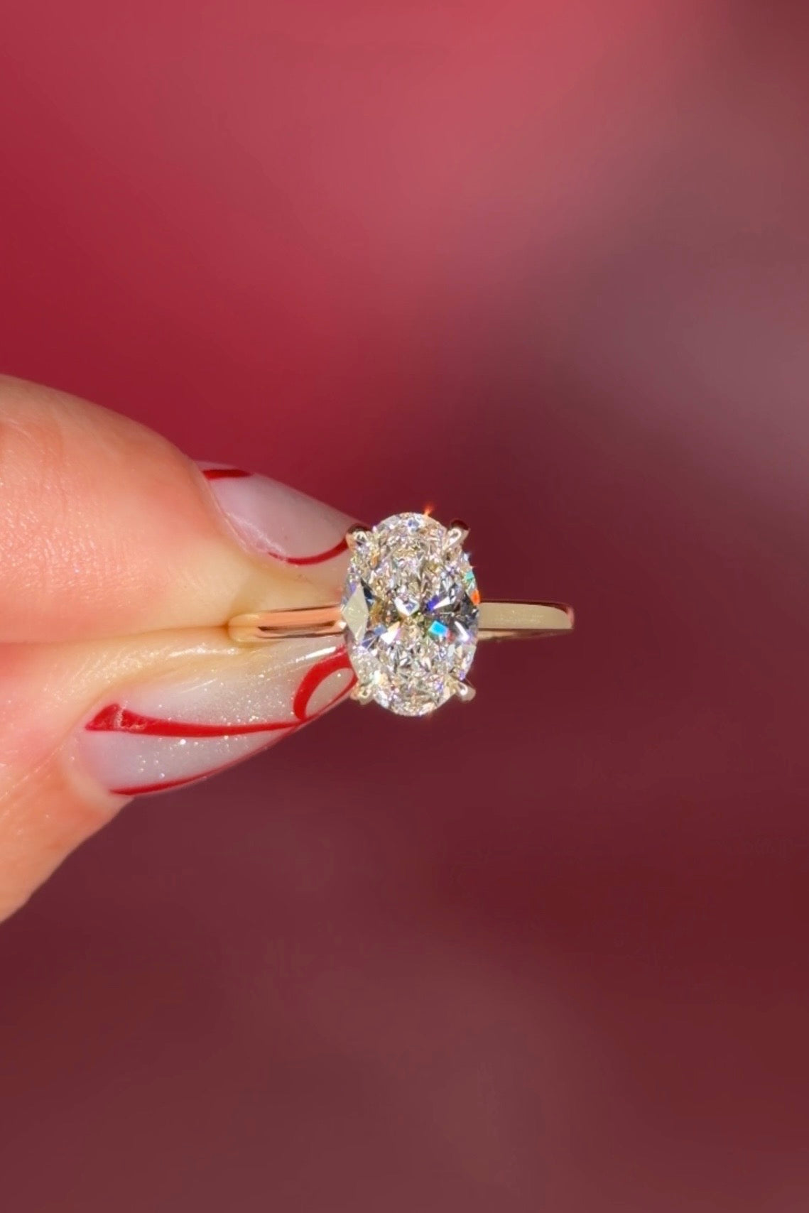 Oval solitaire with hidden halo and diamond bridge in yellow gold