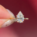 pear lab diamond solitaire engagement ring with flower petal prong basket yellow gold