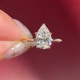 pear lab diamond solitaire engagement ring with flower petal prong basket yellow gold