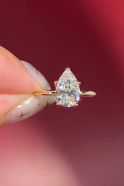 pear lab diamond solitaire engagement ring with flower petal prong basket yellow gold