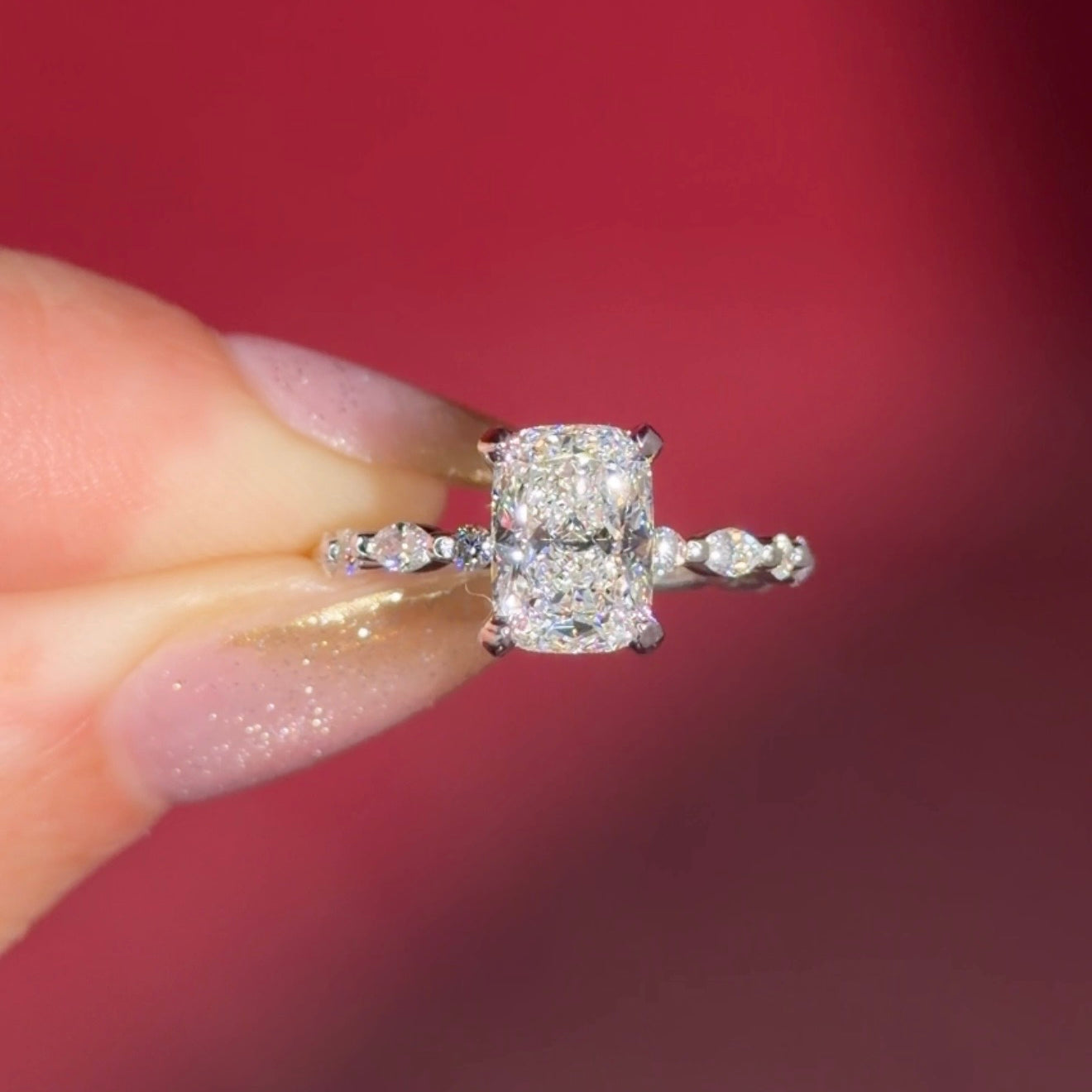 The Rei is a traditional style engagement ring featuring a hidden halo set between the prongs, adding subtle sparkle beneath the center stone.

The standout detail of this design is the floating marquise and round side diamonds, each held by a single prong. This setting allows each side diamond to be fully visible from every angle, creating a light, airy, and elegant look.

Because of this construction, Rei is a more delicate and high maintenance style, best suited for those who are mindful with daily wear 