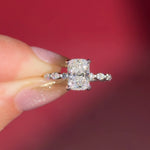 The Rei is a traditional style engagement ring featuring a hidden halo set between the prongs, adding subtle sparkle beneath the center stone.

The standout detail of this design is the floating marquise and round side diamonds, each held by a single prong. This setting allows each side diamond to be fully visible from every angle, creating a light, airy, and elegant look.

Because of this construction, Rei is a more delicate and high maintenance style, best suited for those who are mindful with daily wear 