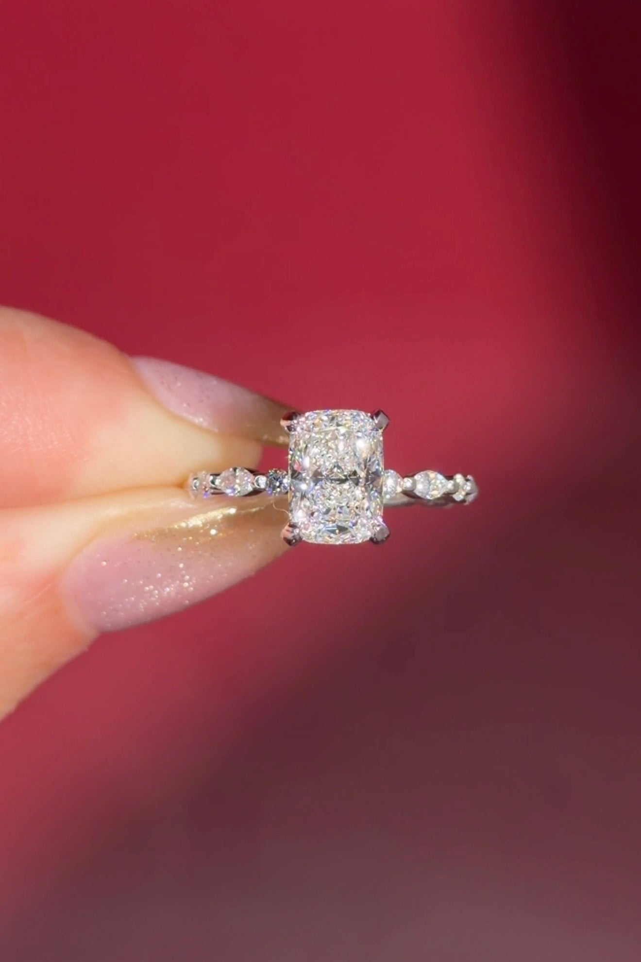 The Rei is a traditional style engagement ring featuring a hidden halo set between the prongs, adding subtle sparkle beneath the center stone.

The standout detail of this design is the floating marquise and round side diamonds, each held by a single prong. This setting allows each side diamond to be fully visible from every angle, creating a light, airy, and elegant look.

Because of this construction, Rei is a more delicate and high maintenance style, best suited for those who are mindful with daily wear 