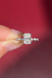 The Rei is a traditional style engagement ring featuring a hidden halo set between the prongs, adding subtle sparkle beneath the center stone.

The standout detail of this design is the floating marquise and round side diamonds, each held by a single prong. This setting allows each side diamond to be fully visible from every angle, creating a light, airy, and elegant look.

Because of this construction, Rei is a more delicate and high maintenance style, best suited for those who are mindful with daily wear 