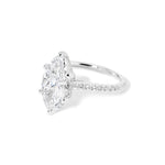 The Alice Marquise lab diamond engagement ring at Princess Bride Diamonds in Huntington Beach, California features a classic pavé diamond band with a cathedral-style setting for a higher, elegant look. It also includes a hidden under-halo beneath the center stone and a diamond bridge for added sparkle from every angle.