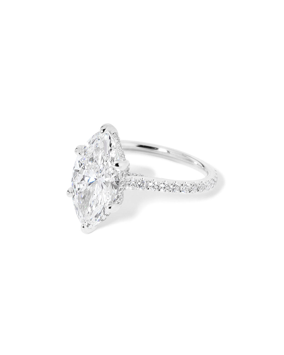 The Alice Marquise lab diamond engagement ring at Princess Bride Diamonds in Huntington Beach, California features a classic pavé diamond band with a cathedral-style setting for a higher, elegant look. It also includes a hidden under-halo beneath the center stone and a diamond bridge for added sparkle from every angle.