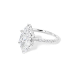 The Alice Marquise lab diamond engagement ring at Princess Bride Diamonds in Huntington Beach, California features a classic pavé diamond band with a cathedral-style setting for a higher, elegant look. It also includes a hidden under-halo beneath the center stone and a diamond bridge for added sparkle from every angle.