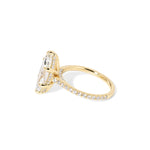 The Alice Marquise lab diamond engagement ring at Princess Bride Diamonds in Huntington Beach, California features a classic pavé diamond band with a cathedral-style setting for a higher, elegant look. It also includes a hidden under-halo beneath the center stone and a diamond bridge for added sparkle from every angle. 14k yellow gold 