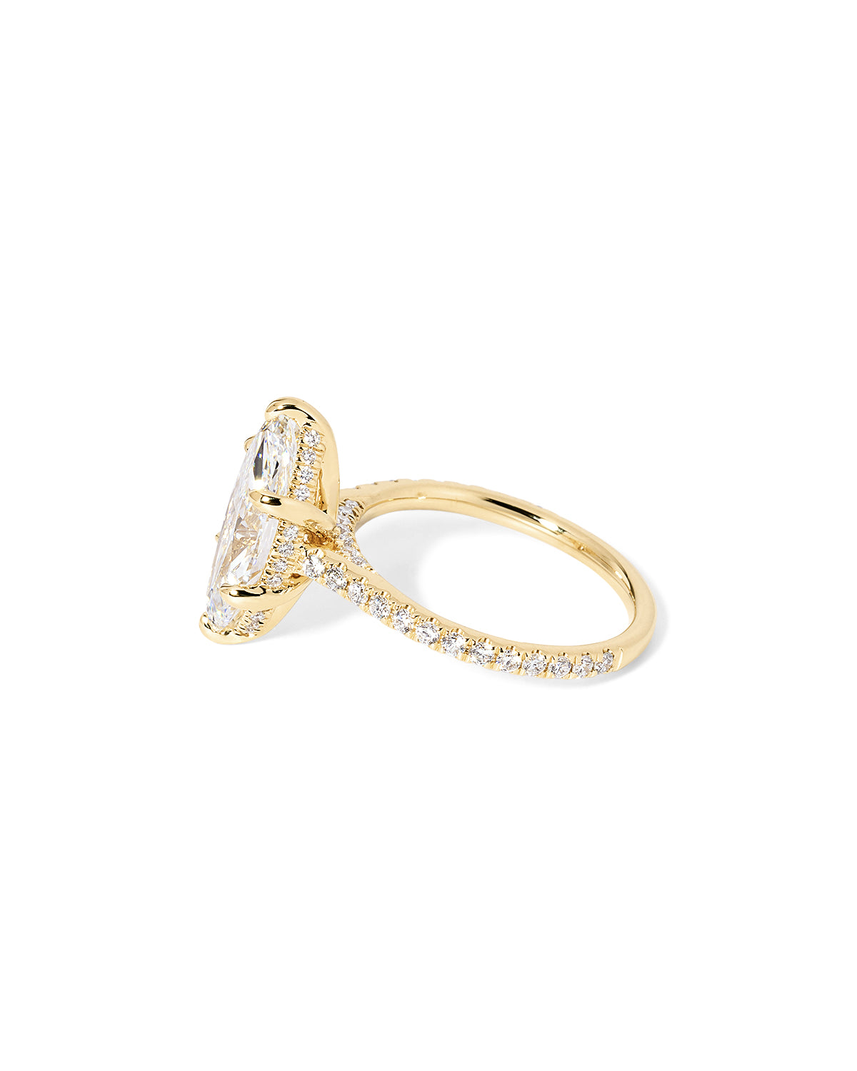 The Alice Marquise lab diamond engagement ring at Princess Bride Diamonds in Huntington Beach, California features a classic pavé diamond band with a cathedral-style setting for a higher, elegant look. It also includes a hidden under-halo beneath the center stone and a diamond bridge for added sparkle from every angle. 14k yellow gold 