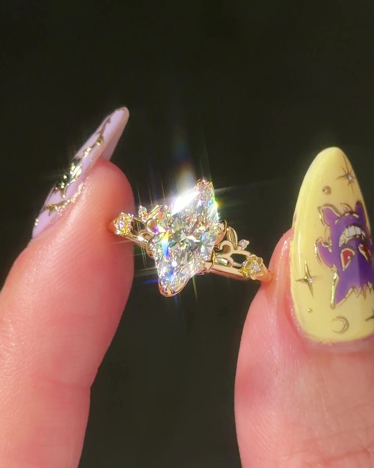 Eryn Marquise engagement ring in 14K yellow gold, marquise lab diamond sparkling between fingers