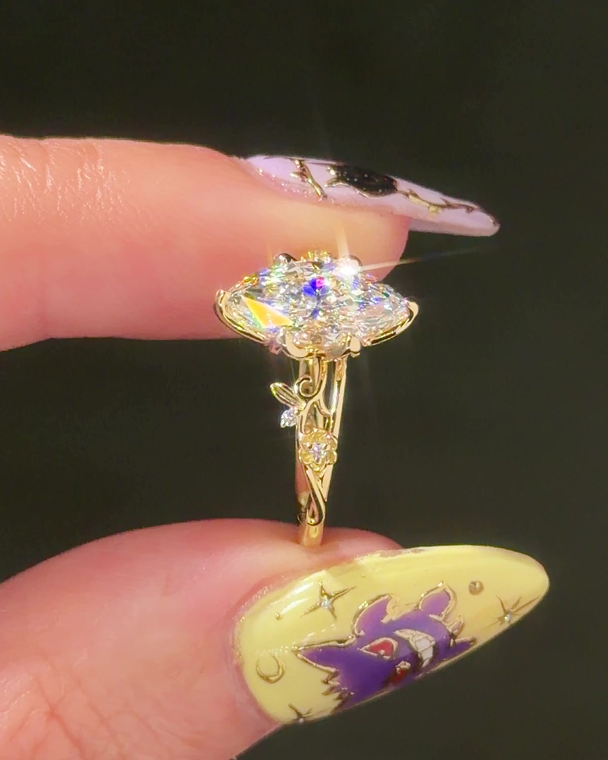 Eryn Marquise engagement ring in 14K yellow gold, side profile showing petal prongs and nature band