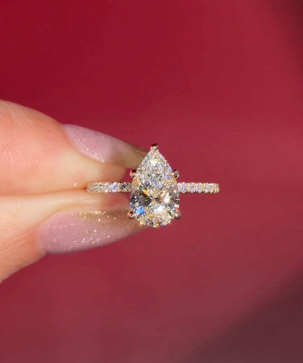 &nbsp;2.00ct D-VVS1 Pear Lab Diamond Kayla. The Kayla is a traditional style body engagement ring with a hidden halo that goes between the prongs, she showcases a classic comfort-fit band, subtly complemented by pave diamonds set on the band.